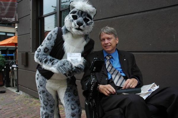 Prestigious Meeting at the launch of Snow Leopard
Wynd has a new life as Nicholai!  He is now owned by the very kind Frysco who hosts the One Fur All Studios website.  In his new life, Nichaolai the snow leopard gets around a lot.  In this case, he got to meet the Mayor of Vancouver for the launch of Apple's new Snow Leopard operating system.   It was a great honor for one of our suits to have such a prestigious outing!  Much thanks to Frysco for this picture.  :)
